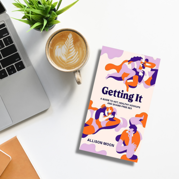Getting It book on a desk that has coffee and a laptop