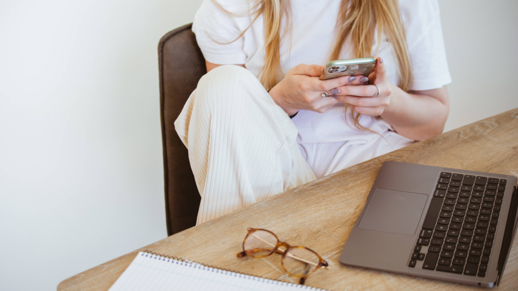 Let's celebrate women in business by looking at a woman working on her laptop and phone