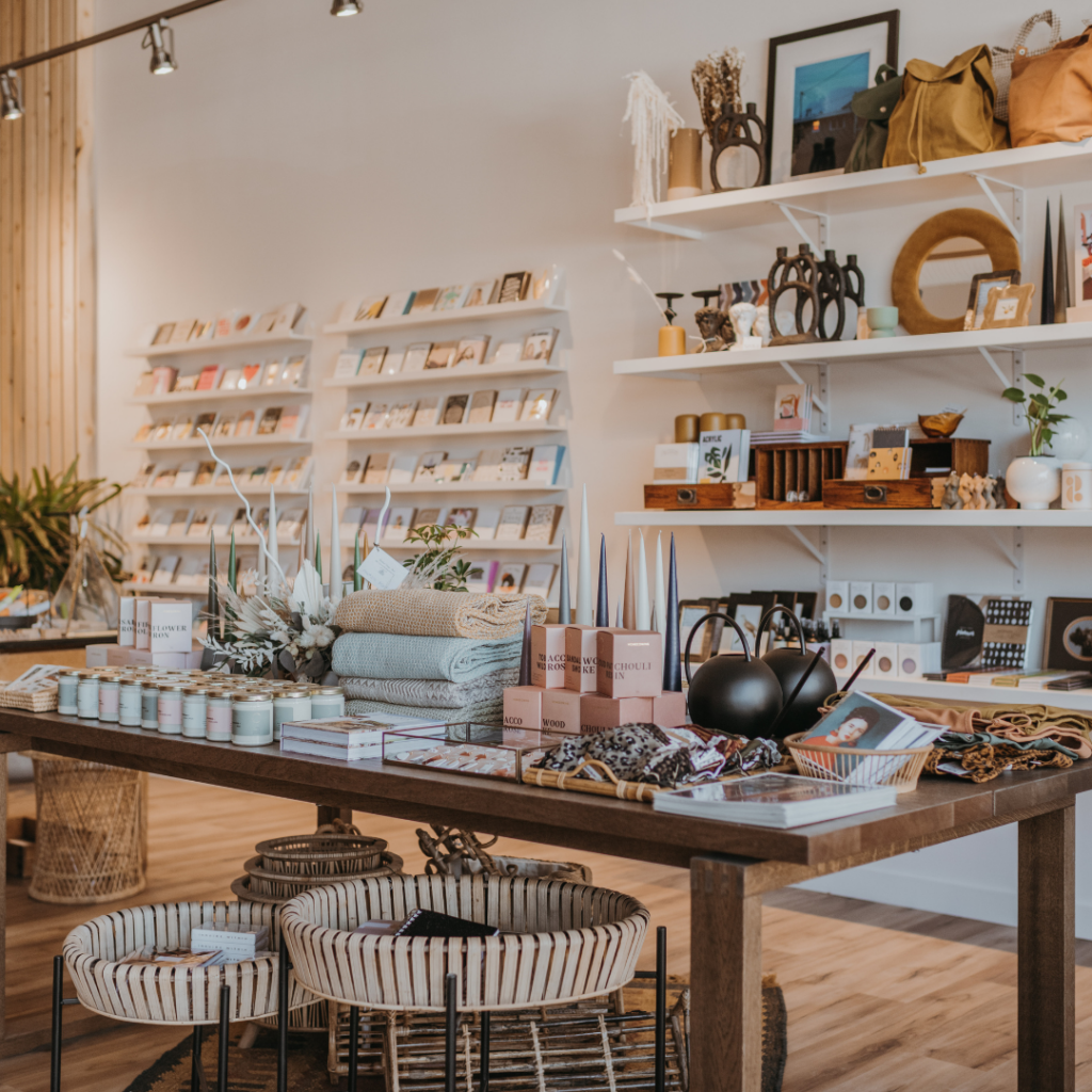 Shelves and tables fully stocked with gift products at Far and Wide in Kamloops, British Columbia. The blog cover for 2024 trends.