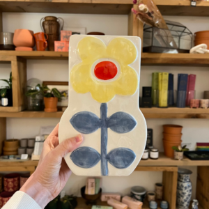 Holding up the buttercup flower vase at Far and Wide shop in Kamloops, British Columbia