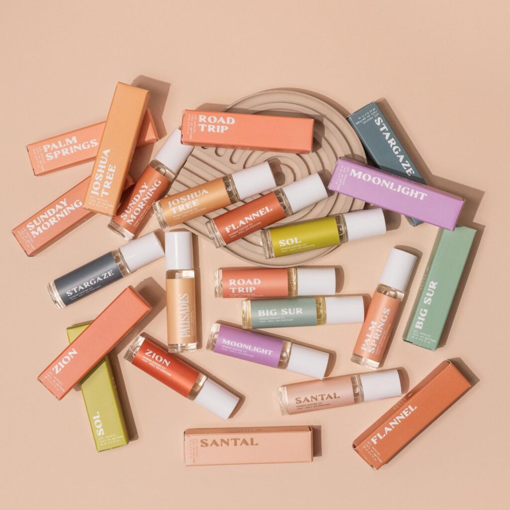 Bottles of perfume rollers scattered on table